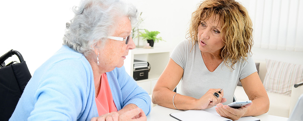 women at a table talking over paperwork